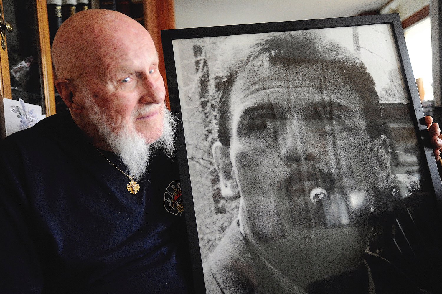 Paternal love. Ernie Bielfeld holds a photograph of Peter, his NYFD firefighter son, who perished during the terrorist attacks on the twin towers of the World Trade Center on 9/11/2001.